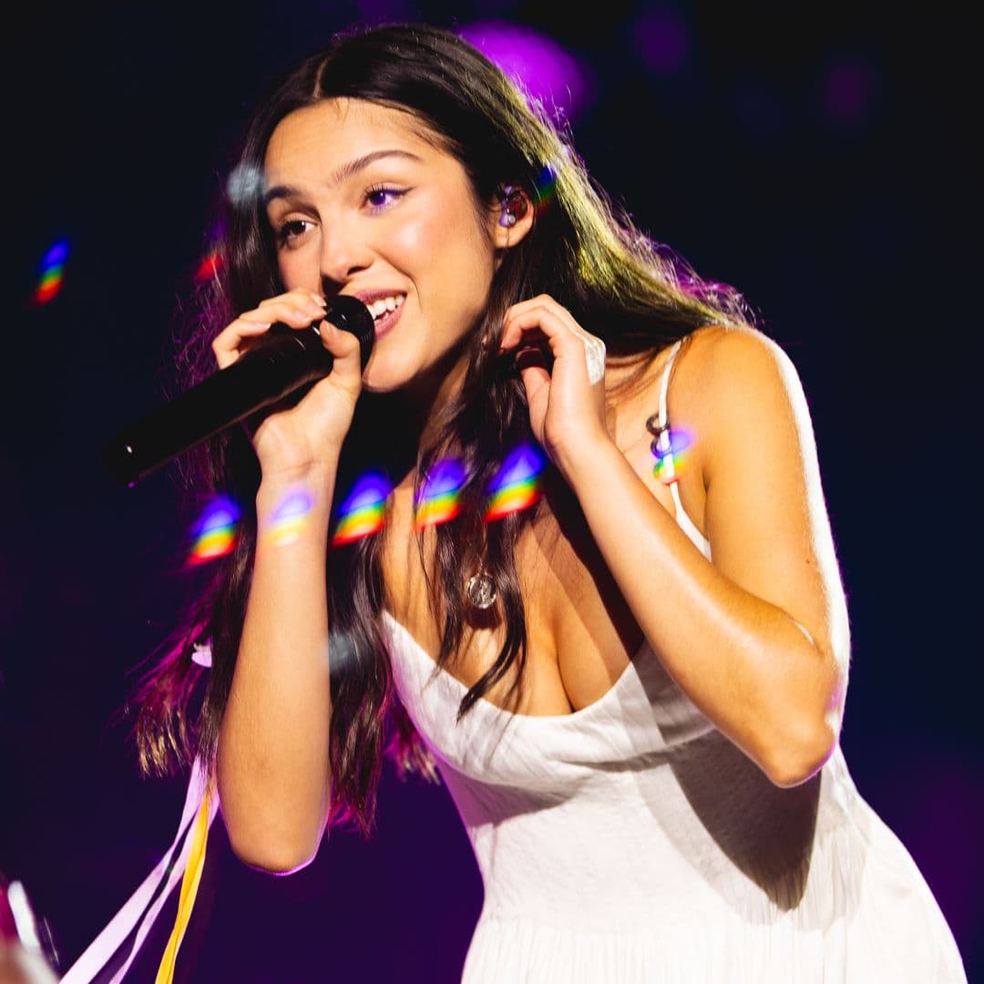  Olivia Rodrigo Epitomizes Festival Dressing in a Lace-Trimmed Mini Dress, Knee-High Lace-Up Boots, and a Talisman Necklace 