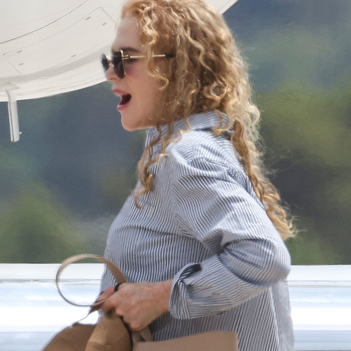 The Row Bag Celebs in Their 50s Pair With Cuffed Jeans and White Sneakers at the Airport